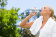 Side view of sportswoman drinking water