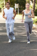 Sportspeople jogging on a countryside road