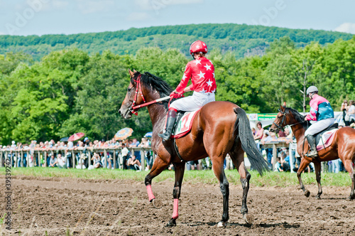 Photo: jockey on racing horse before the start jockey on racing horse before the start