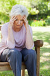 Woman with a worried expression sittting on a bench
