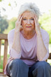 Woman gazing at something while holding her head