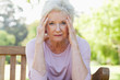 Woman looking ahead while holding her head