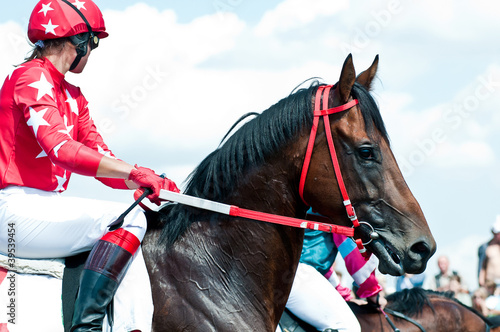Photo: jockey on racing horse before the start jockey on racing horse before the start