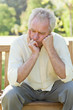 Man with a disappointed expression resting his face in his hands