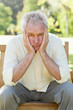 Disappointed man sitting on a bench