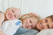 Close up of a mother and her kids lying across the couch