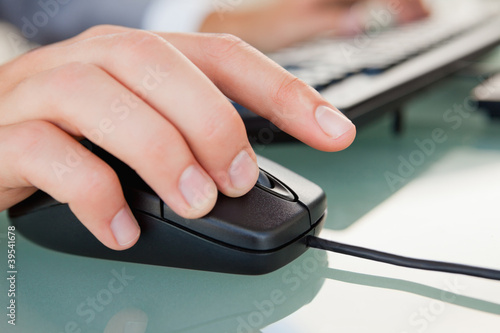 Photo: Close-up of man hand clicking with a mouse Close-up of man hand clicking with a mouse