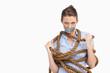 Businesswoman trying to untie herself