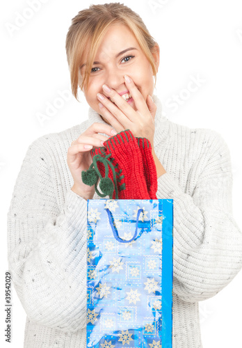 Photo: young woman taking out gift from present bag young woman taking out gift from present bag