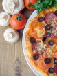 Pizza with tomato, sausage, mushrooms, cheese, olives