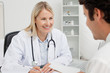 Smiling doctor talking with her patient