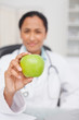 Beautiful green apple being held by a nurse