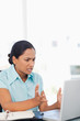 Foto: Angry young secretary looking at her laptop Angry young secretary looking at her laptop