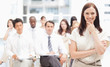 Photo: Brown haired businesswoman holding her hand against her chin Brown haired businesswoman holding her hand against her chin