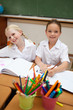 Smiling girls painting during class