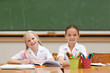 Smiling girls painting at desk