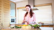 Young woman cutting peppers