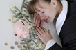 Business woman sleeping on a table in money