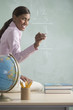 Female teacher at chalkboard