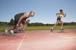 Three people racing on track