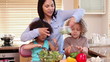 Mother cooking with her children