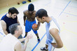 High angle view of coach talking to basketball team