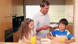 Father bringing breakfast to his children