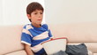 Boy eating popcorn in front of the TV