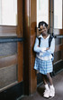 Portrait of girl standing in hallway at school