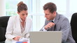 Colleagues working behind a laptop