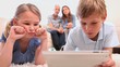 Smiling children playing with a tablet pc