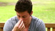 Video: Disappointed man putting his face in his hands while shaking his head as he sits on a bench Disappointed man putting his face in his hands while shaking his head as he sits on a bench