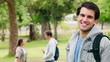 Video: Man laughing before turning and looking at the camera as he stands in a park Man laughing before turning and looking at the camera as he stands in a park