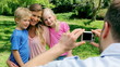 Mother and her children pose for a picture being taken by the father