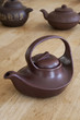 A collection of antique ceramic Asian teapots