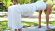 A woman holding a yoga position in the park