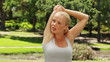 Woman stretching her arms and then looking at the camera and smiling