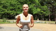 Video: Woman jogging in the park towards the camera Woman jogging in the park towards the camera