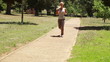 A woman jogs up a footpath past the camera