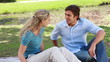 Video: A man sits down beside his girlfriend and gives her a kiss before they talk together A man sits down beside his girlfriend and gives her a kiss before they talk together