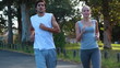 A couple jog together as the camera fades twice to them at different places