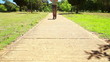 A low angle video of a woman running down towards the camera