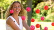 Blonde woman in slow motion sitting behind balls