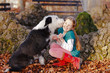 dog is kissing young girl