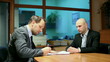 Business partners handshake after signing new contract