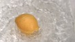 Lemon turning in water in super slow motion