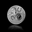 silver coin with horseshoes isolated on black