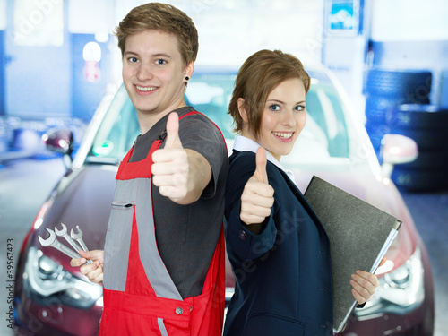 Photo: Apprentices for car mechanic and the office show thumbs up Apprentices for car mechanic and the office show thumbs up