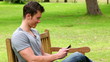 Video: Man laughing as he reads a text message before looking towards the camera and smiling Man laughing as he reads a text message before looking towards the camera and smiling