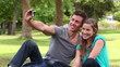 Video: Two friends sitting together before using a camera to take a picture of themselves Two friends sitting together before using a camera to take a picture of themselves